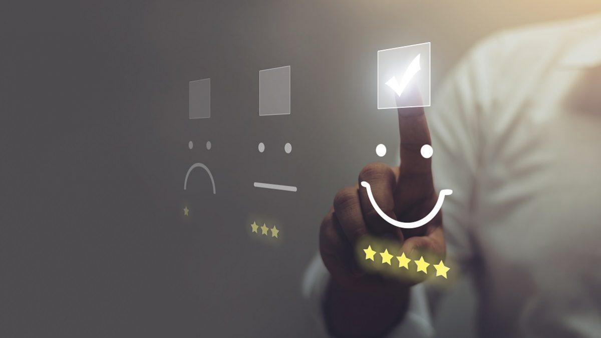 Businessman pressing smiley face emoticon on virtual touch screen. Customer service evaluation concept.