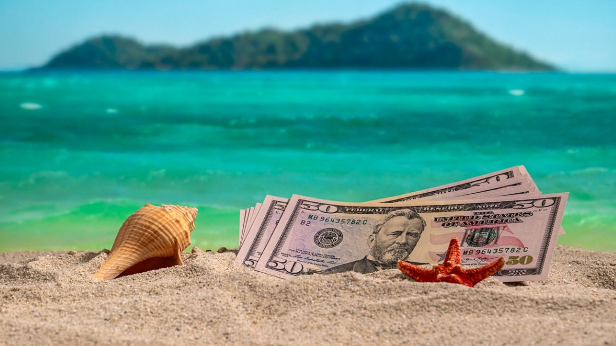 banknotes-of-50-dollars-on-the-beach-at-sunset-picture-id1167701641