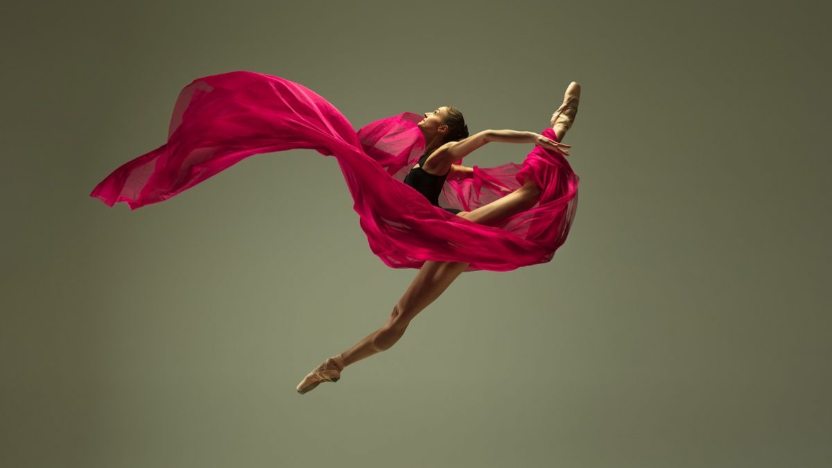 Graceful ballet dancer or classic ballerina dancing isolated on grey studio background. Woman with the pink silk cloth. The dance, grace, artist, contemporary, movement, action and motion concept.